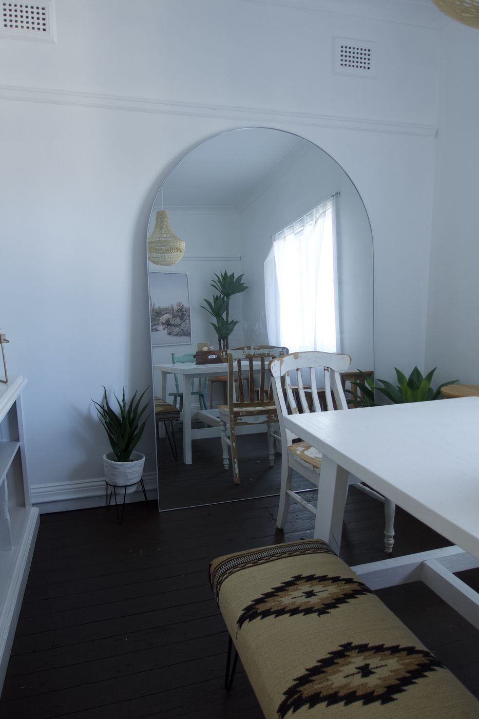 Mami's private back dining room with a long white table and woven bench seats